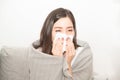 Asian women with stress that suffer from allergies and close the nose with tissue paper. Because of having sneezing all the time.