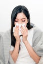 Asian women with stress that suffer from allergies and close the nose with tissue paper. Because of having sneezing all the time.