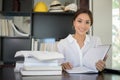 Asian women student smiling and reading a book for relaxation Royalty Free Stock Photo