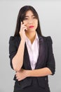 Asian women in suit standing posing using phone