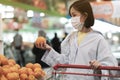 Asian women and surgical mask shopping some food in supermarket, covid-19 crisis Royalty Free Stock Photo