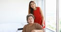 Asian woman take care of her grandmother in wheelchair at home