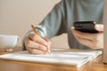 Asian women take notes with a pencil in the office, business woman working on table