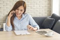 Asian women talk via smartphone work from home small office desk. Young asian Woman hands holding phone technology lifestyle. Royalty Free Stock Photo