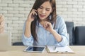 Asian women talk via smartphone work from home small office desk. Young asian Woman hands holding phone technology lifestyle. Royalty Free Stock Photo