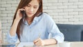 Asian women talk via smartphone work from home small office desk. Young asian Woman hands holding phone technology lifestyle. Royalty Free Stock Photo