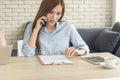 Asian women talk via smartphone work from home small office desk. Young asian Woman hands holding phone technology lifestyle. Royalty Free Stock Photo