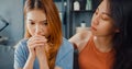 Asian women teenager embracing to calm her sad best friends from feeling down from breakup with boyfriend in living room at home. Royalty Free Stock Photo