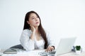 Asian women are tired from work, sit in a chair, stretch and massage neck, arm, shoulder For relaxation while working hard at the Royalty Free Stock Photo