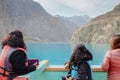 Tourists enjoy beautiful scenery of Attabad lake. Gilgit Baltistan, Pakistan.