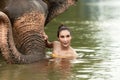 Asian women traditional hug friendly with the wild elephant in river at Kanchanaburi province in Thailand for the outdoors trips v