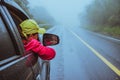 Asian women travel relax in the holiday. driving a car traveling happily. Amid the mist rainy