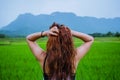 Asian women travel relax in the holiday.The girl smiled happy and enjoyed the rain that was falling. travelling in countrysde, Royalty Free Stock Photo