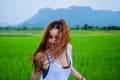 Asian women travel relax in the holiday.The girl smiled happy and enjoyed the rain that was falling. travelling in countrysde, Royalty Free Stock Photo