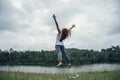 Asian women travel relax in the holiday. Jump on a green pasture