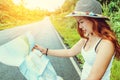 Asian women travel relax in the holiday. Take a look at the map on a rural road in the middle of nature. Thailand