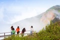 Asian woman traveler see sunrise and take photo from top of mountain in spring season Royalty Free Stock Photo