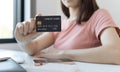 Asian women use a credit card to pay through online purchases, Payment by credit card or online banking, Shopping and mail
