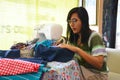 Asian women use machine sewing clothes