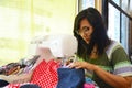 Asian women use machine sewing clothes