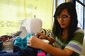 Asian women use machine sewing clothes