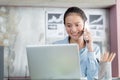 Asian women are using laptops and phoning in office Royalty Free Stock Photo