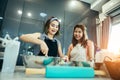 Asian women are using the mixture and help the cream for making the birthday cake