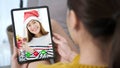 Asian woman video call for greeting in Christmas celebration, Woman hand holding digital tablet while talking with friend in