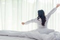 Asian women waking up stretching in bed room at home, Royalty Free Stock Photo