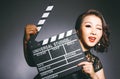 Asian women wear cheongsams and carry movie boards Royalty Free Stock Photo