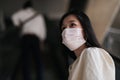Asian women wear surgical face masks to protect The Covid-19 in public areas