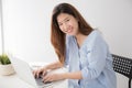 Asian women wearing casual dresses using computer laptop on desk at home, Concepts lifestyle and self study