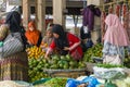 Asian women wearing hijab buying fresh avocadoes at traditional market in Takengon, Aceh Indonesia