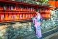 Asian women wearing japanese traditional kimono visiting the beautiful in Fushimi Inari Shrine in Kyoto, Japan Royalty Free Stock Photo