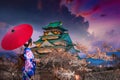 Asian women wearing kimonos See cherry blossoms in the evening around the Osaka Castle, Japan Royalty Free Stock Photo