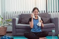 Asian women wiping their sweat away after exercising at home