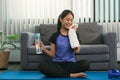 Asian women wiping their sweat away after exercising at home