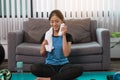 Asian women wiping their sweat away after exercising at home