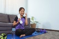 Asian women wiping their sweat away after exercising at home