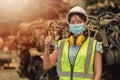 Asian women worker thumbs up waring face mask happy working safety work in a heavy industrial factory with engine machine