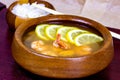 Asian wooden bowl with traditional light spicy thai cuisine rice and tom yam soup with shrimps, seafood and lemon on board Royalty Free Stock Photo