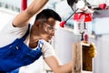 Asian worker on drill in production factory Royalty Free Stock Photo