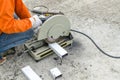 asian worker with machine cutting metal and welded steel to create a roof, local labor construction concept