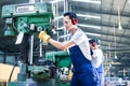 Asian worker in production factory drilling Royalty Free Stock Photo