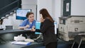 Asian worker talking to medical assistant at hospital reception Royalty Free Stock Photo