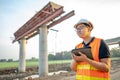 Asian worker using digital tablet at construction site Royalty Free Stock Photo