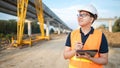 Asian worker using digital tablet at construction site Royalty Free Stock Photo