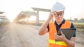 Asian worker using digital tablet at construction site Royalty Free Stock Photo