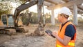 Asian worker using digital tablet at construction site Royalty Free Stock Photo