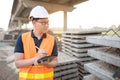 Asian worker using digital tablet at construction site Royalty Free Stock Photo